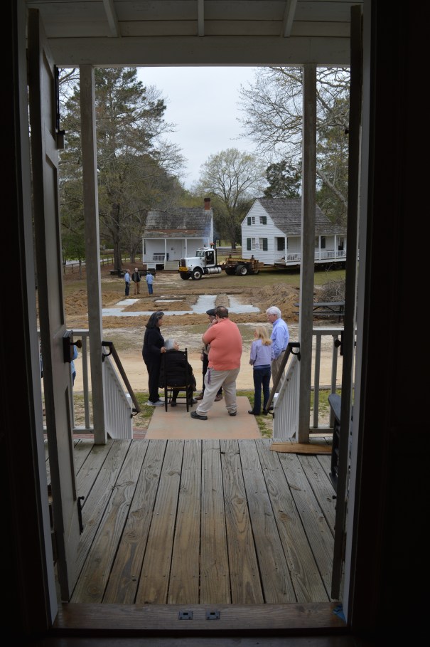 Seated, Bonds Conway descendant Elsie Goins, along with her daughter Felicia and members of KCHS and Historic Camden, watches as the Bonds Conway House is moved to its new site in 2022.